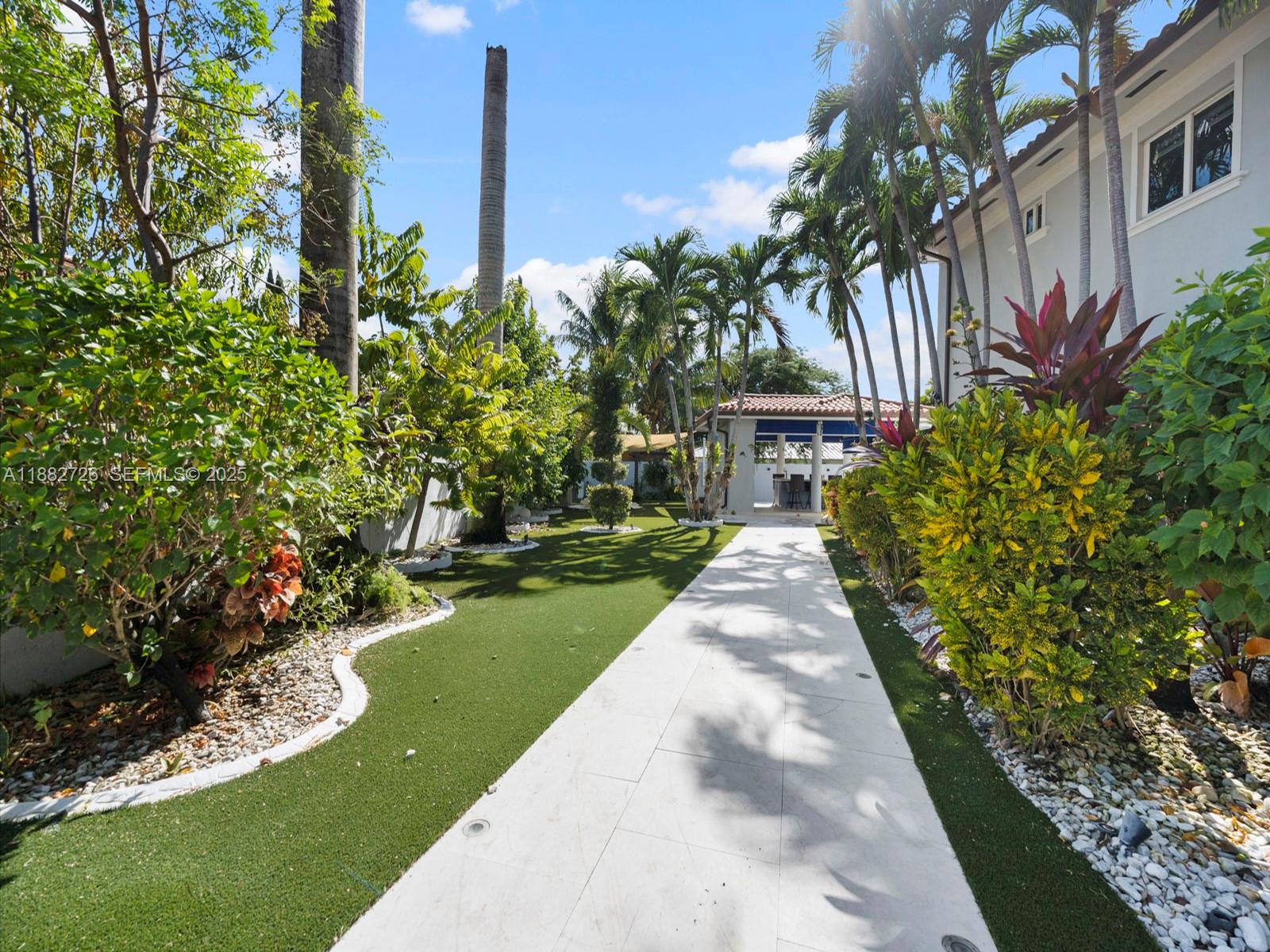 12770 Southwest 188th Street Miami, FL 33177 - Photo 62 of 65 a front view of a house with a yard and potted plants