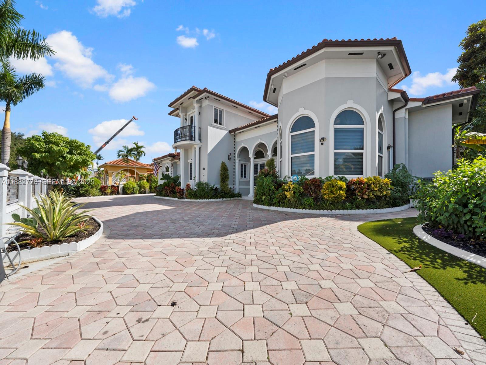 12770 Southwest 188th Street Miami, FL 33177 - Photo 65 of 65 a front view of a house with a yard and potted plants