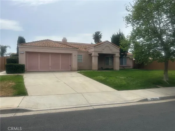 a front view of a house with yard and green space