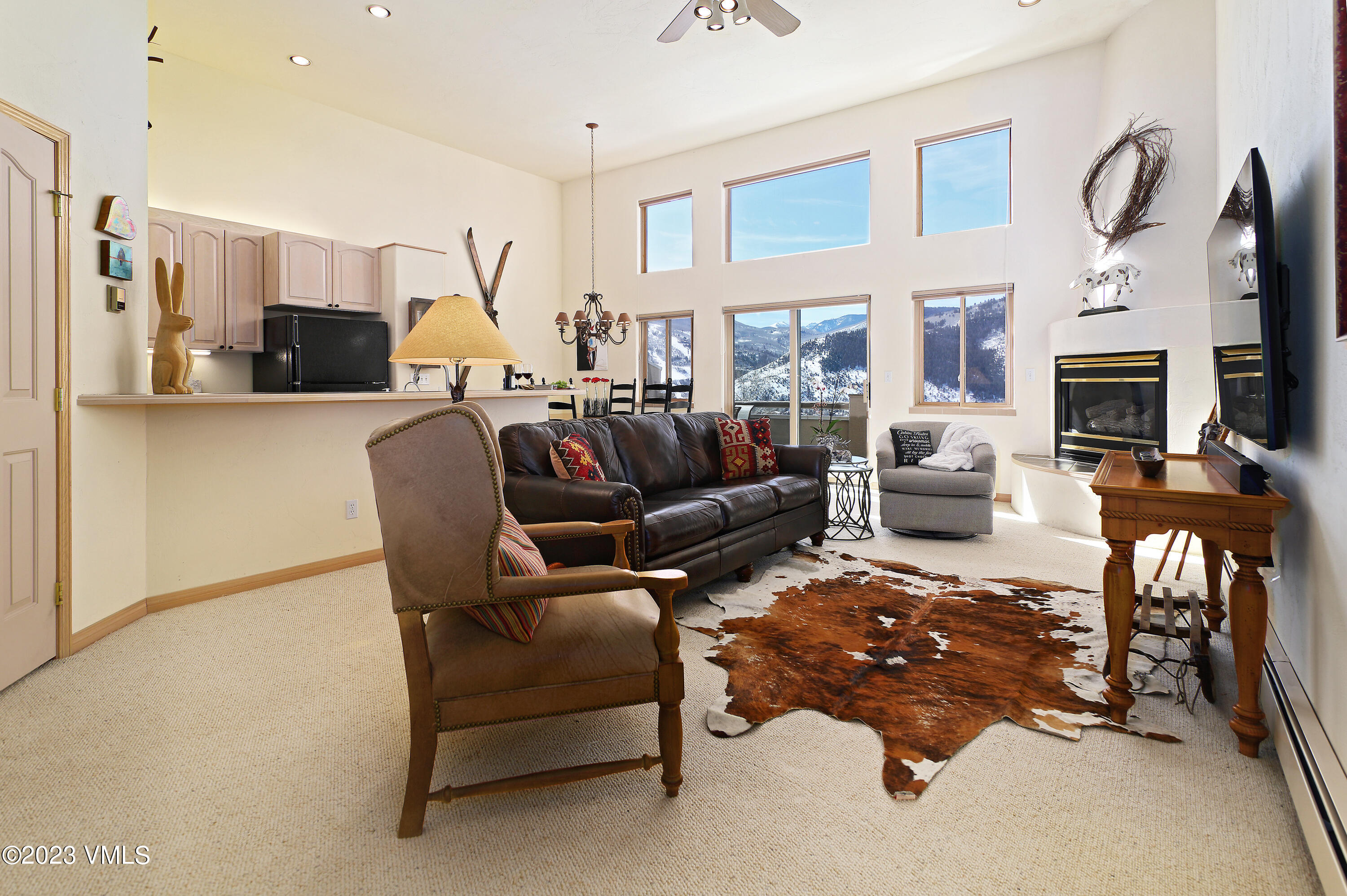 751 Singletree Road, Unit 6 Edwards, CO 81632 - Photo 2 of 30 a living room with furniture a fireplace and a flat screen tv