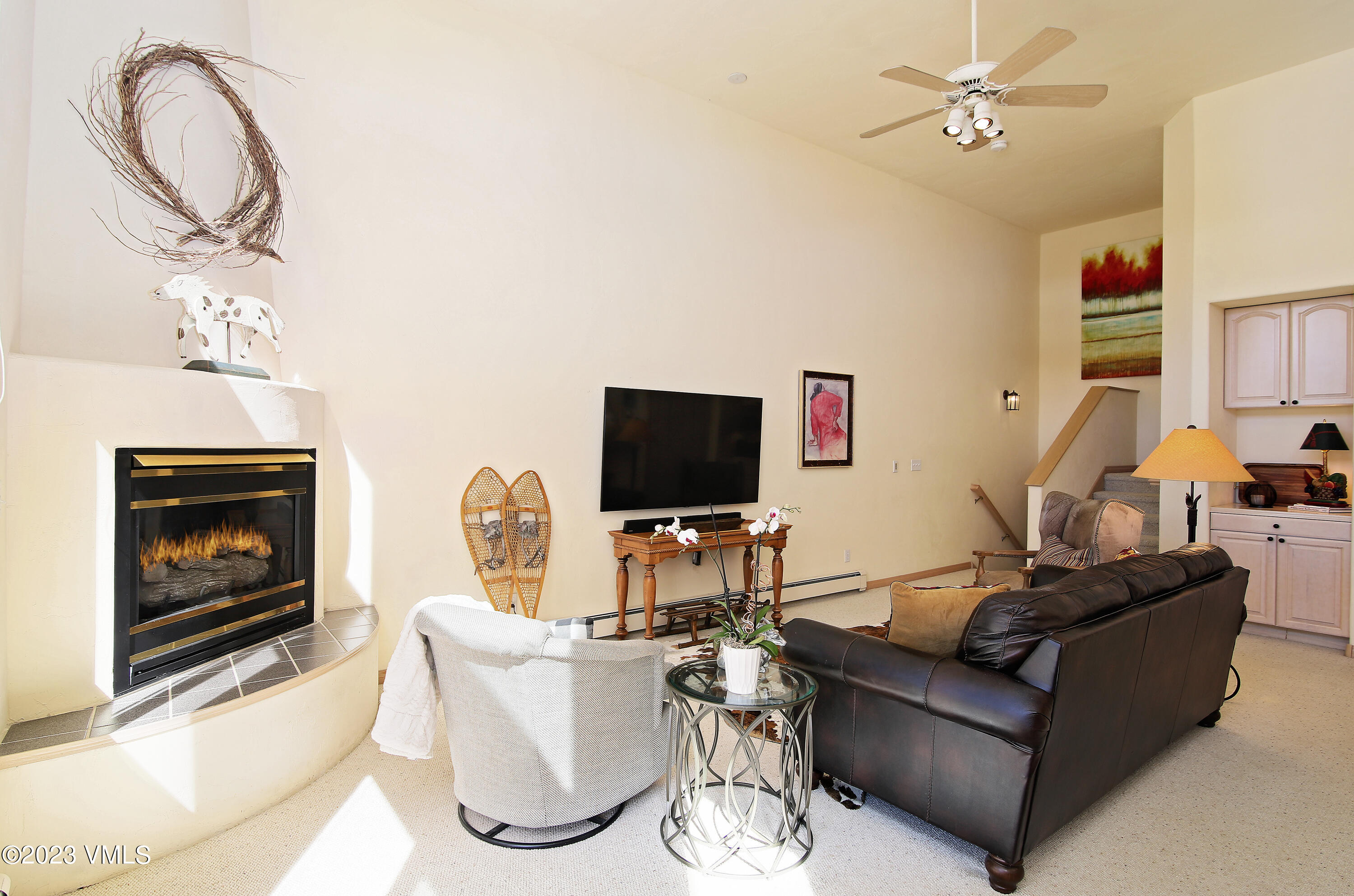 751 Singletree Road, Unit 6 Edwards, CO 81632 - Photo 26 of 30 a living room with furniture a flat screen tv and a fireplace