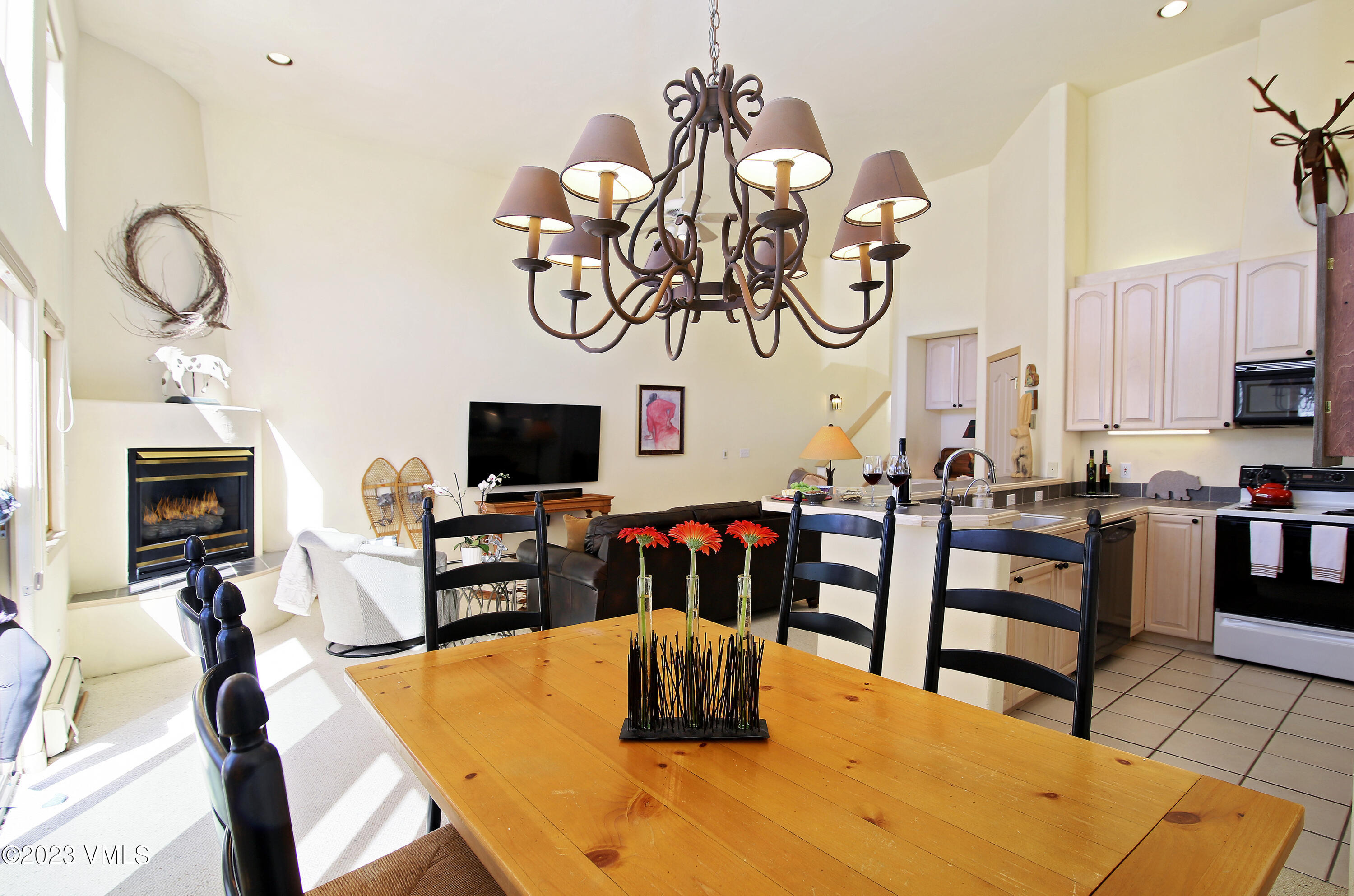 751 Singletree Road, Unit 6 Edwards, CO 81632 - Photo 27 of 30 a dining room with furniture a flat screen tv and kitchen view