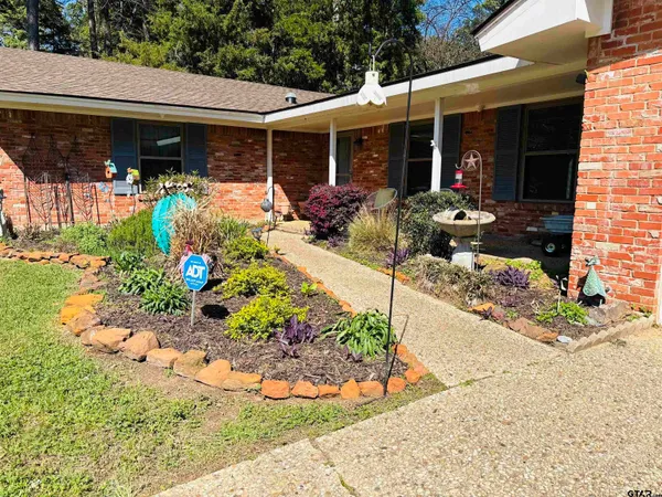 a view of a patio with table and chairs potted plants