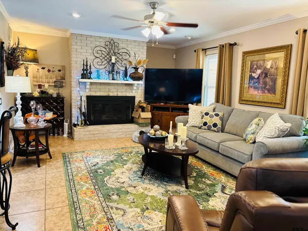a living room with lots of furniture and a view of kitchen