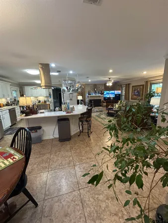 a living room with furniture and a dining table