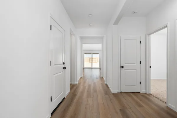a view of a hallway with wooden floor