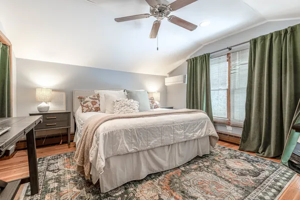 a bedroom with a bed and a dresser