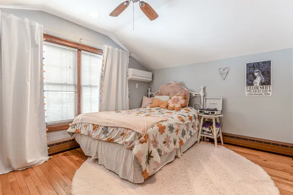 a bedroom with a bed and a large window