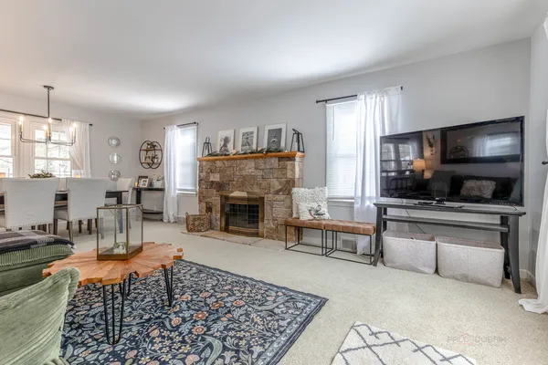 a living room with furniture a flat screen tv and a fireplace