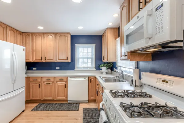 a kitchen with stainless steel appliances granite countertop a stove a sink and a refrigerator