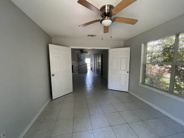 a view of a livingroom with a ceiling fan and window