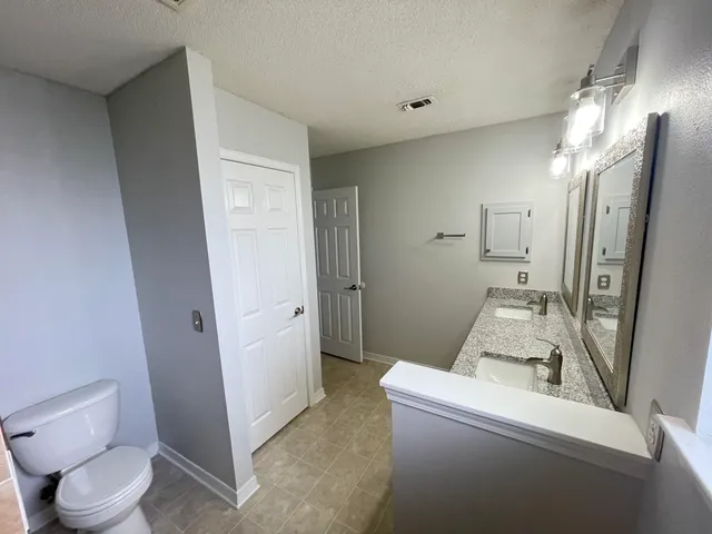 a living room with a toilet and a sink