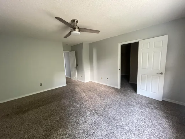 a view of empty room with ceiling fan