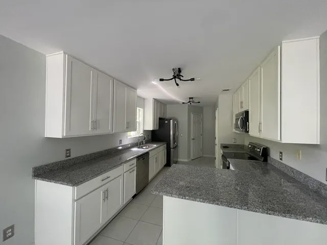 a kitchen with a sink stove and cabinets