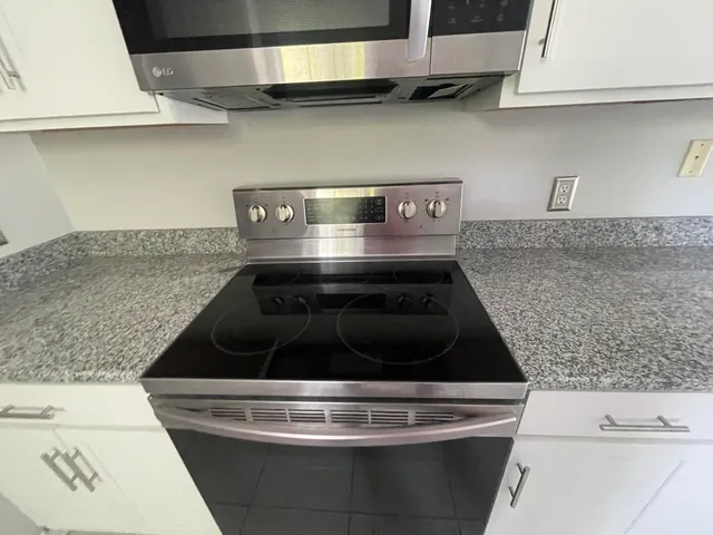a stove top oven sitting inside of a kitchen