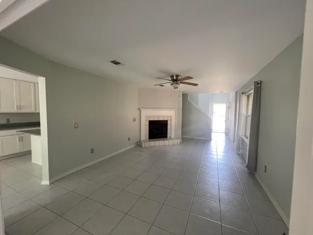a view of a livingroom with a fireplace and a window