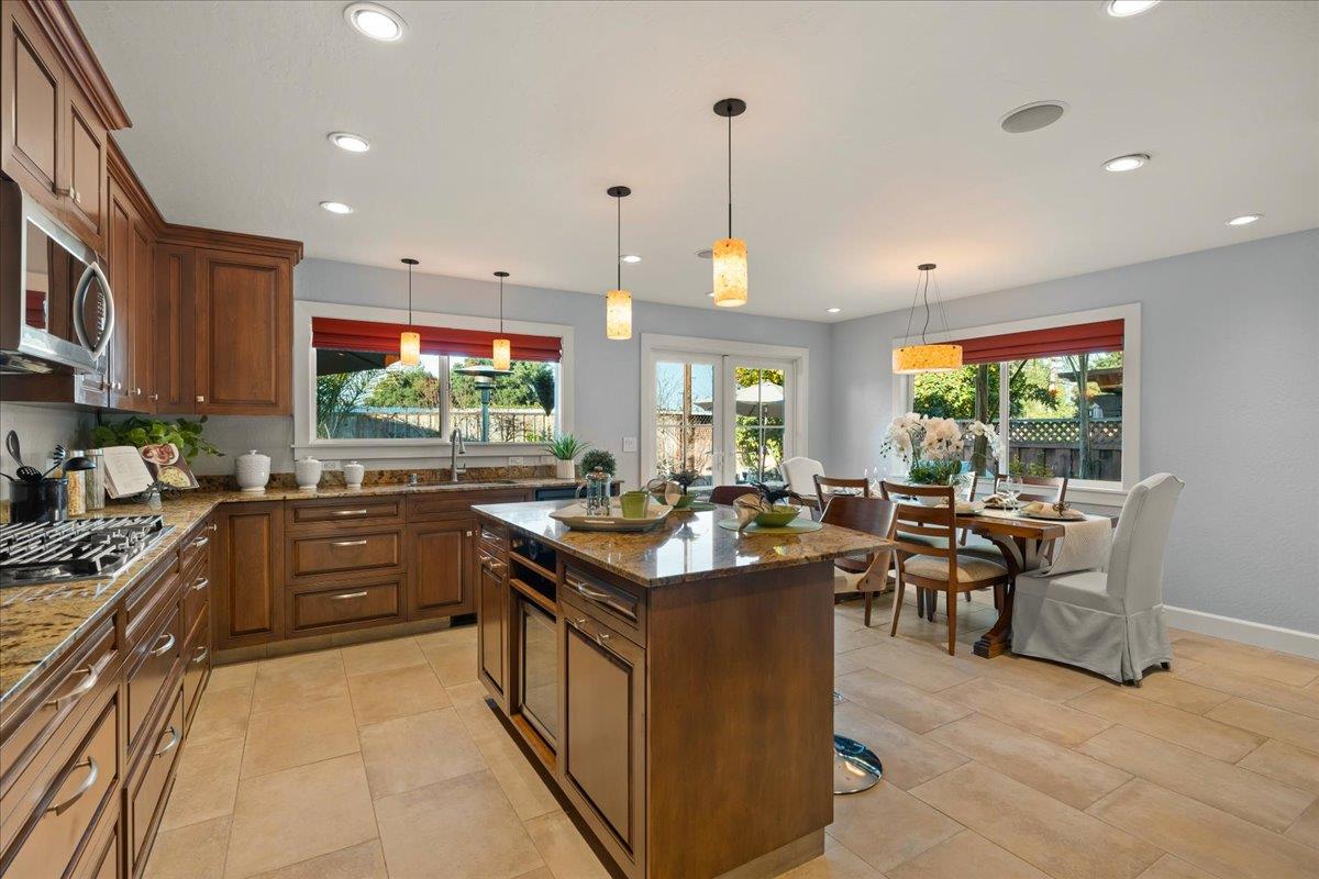 159 Anne Way Los Gatos, CA 95032 - Photo 19 of 50 a kitchen with stainless steel appliances granite countertop a stove and a view of living room