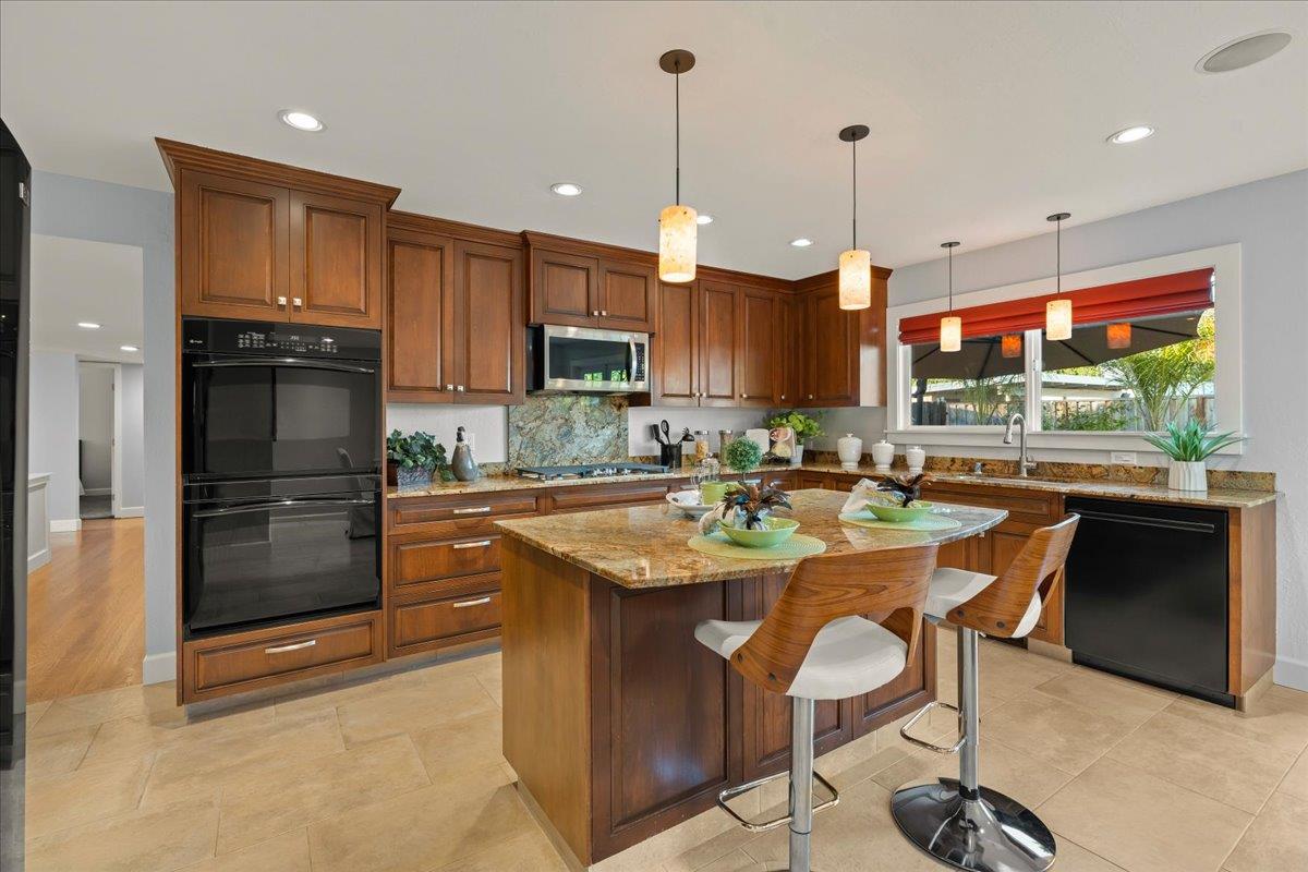 159 Anne Way Los Gatos, CA 95032 - Photo 20 of 50 a kitchen with stainless steel appliances granite countertop a stove a sink and a refrigerator