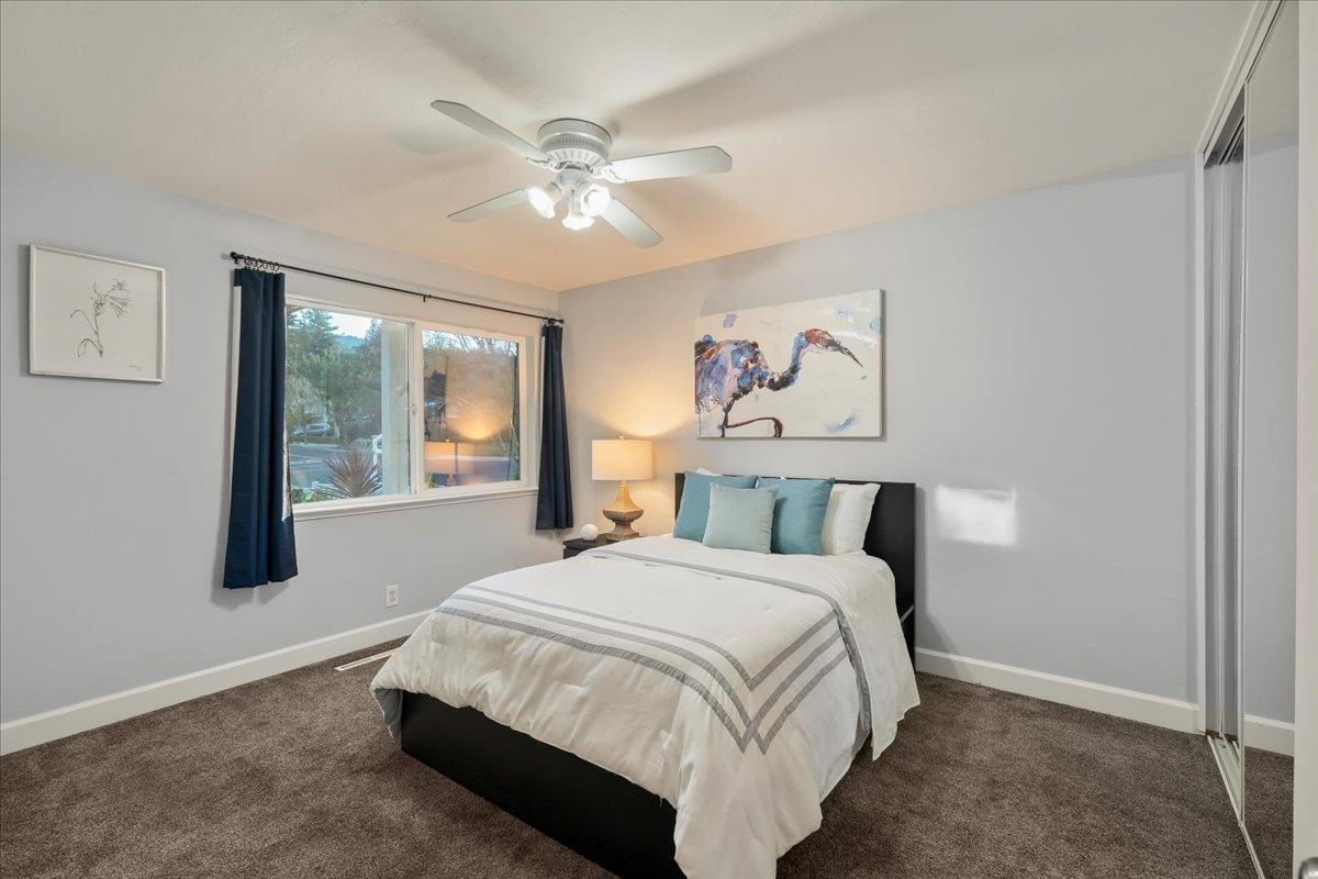 159 Anne Way Los Gatos, CA 95032 - Photo 36 of 50 a bedroom with a large bed and a chandelier