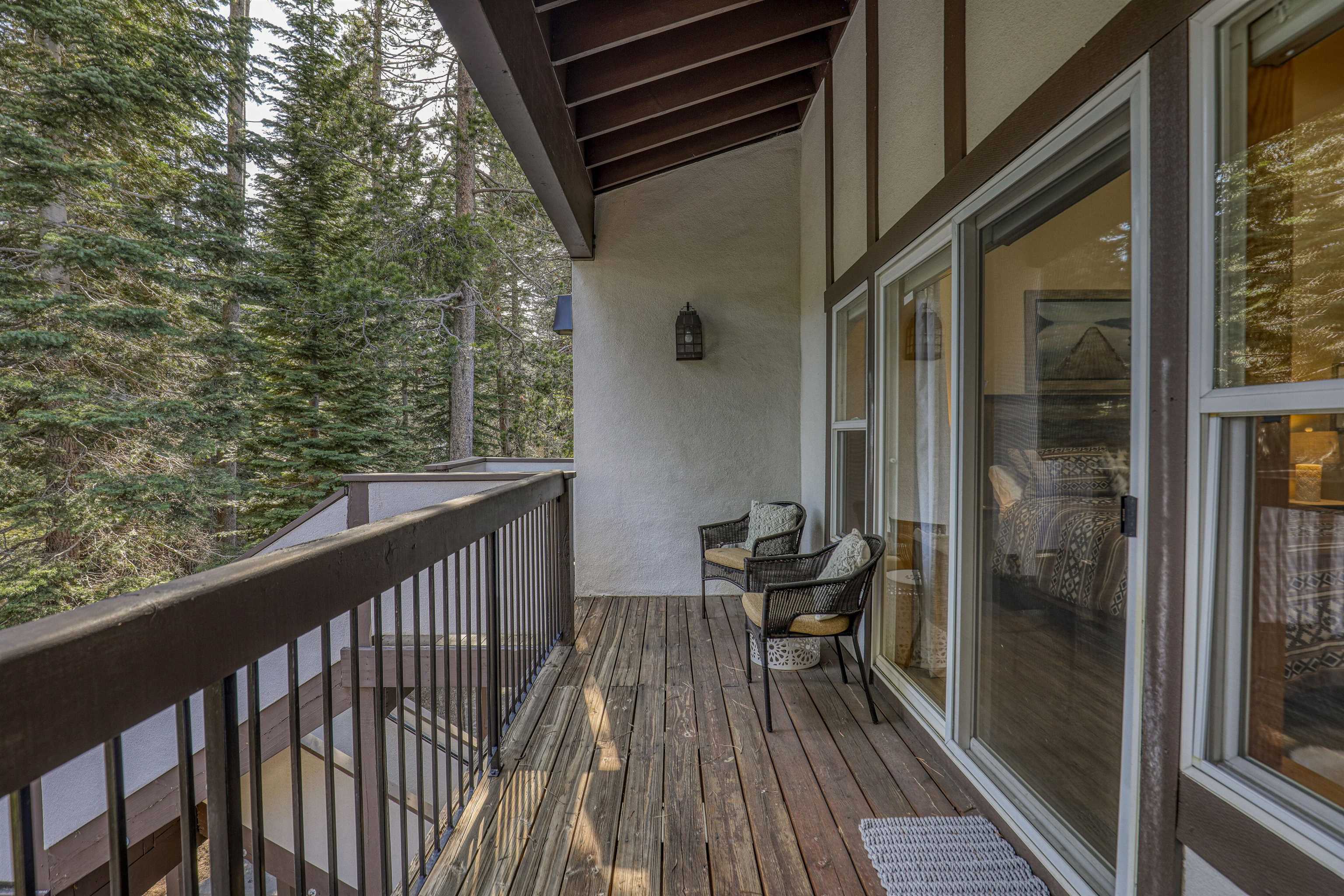 227 Olympic Vly Road, Unit 52 Olympic Valley, CA 96146 - Photo 15 of 21 a balcony with wooden floor table and chairs