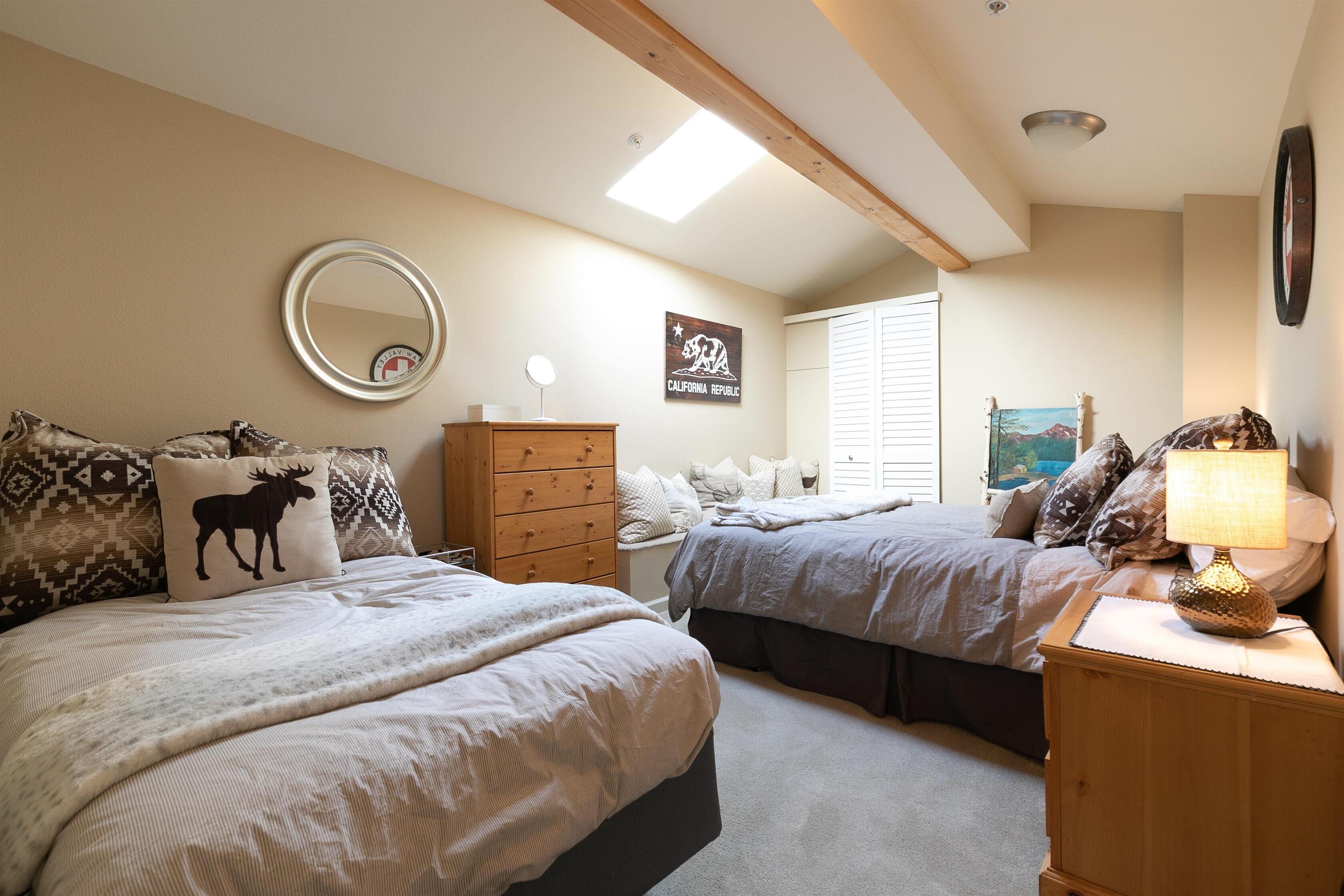 227 Olympic Vly Road, Unit 52 Olympic Valley, CA 96146 - Photo 19 of 21 a bedroom with double bed and a chandelier