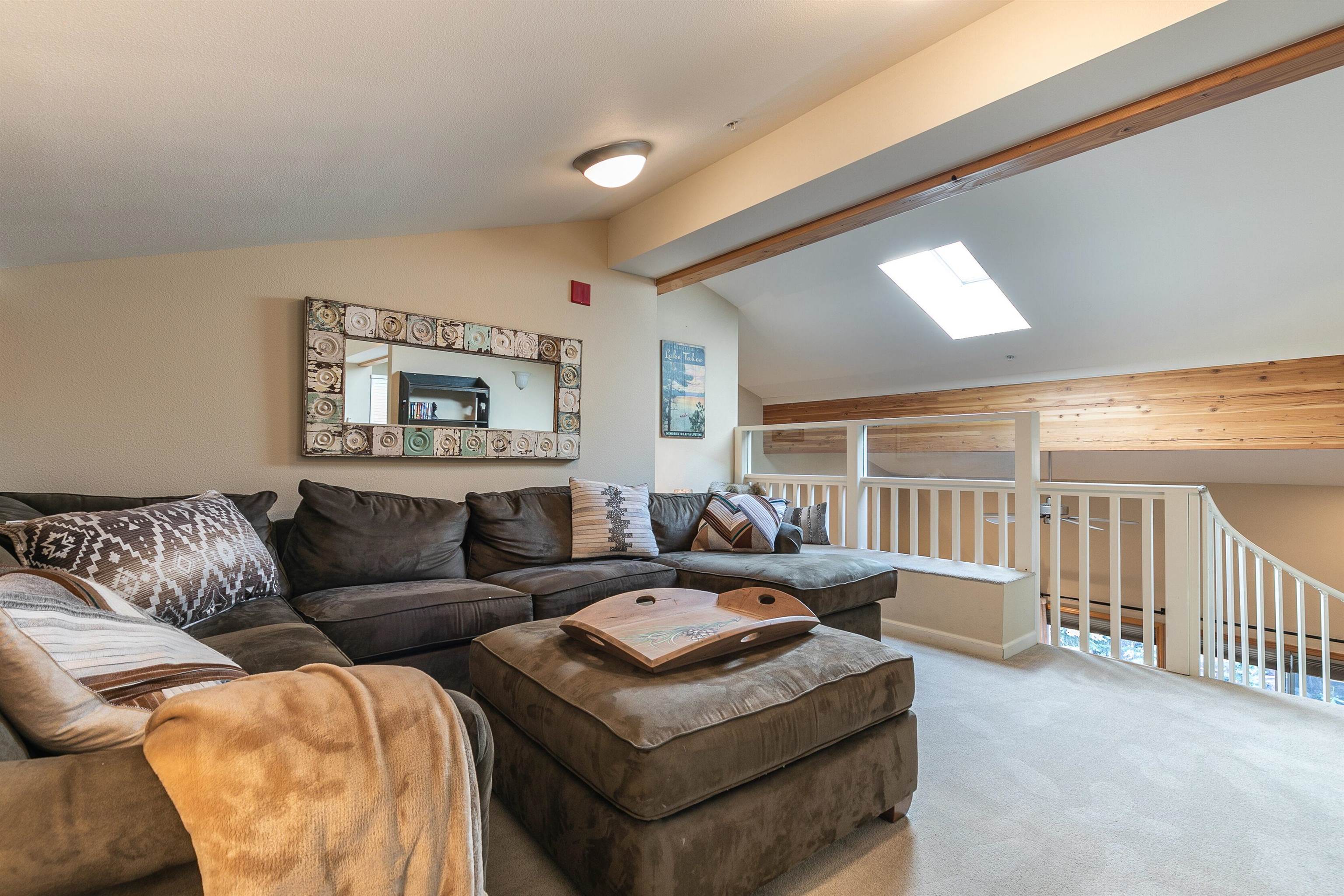 227 Olympic Vly Road, Unit 52 Olympic Valley, CA 96146 - Photo 8 of 21 a living room with furniture and a large window