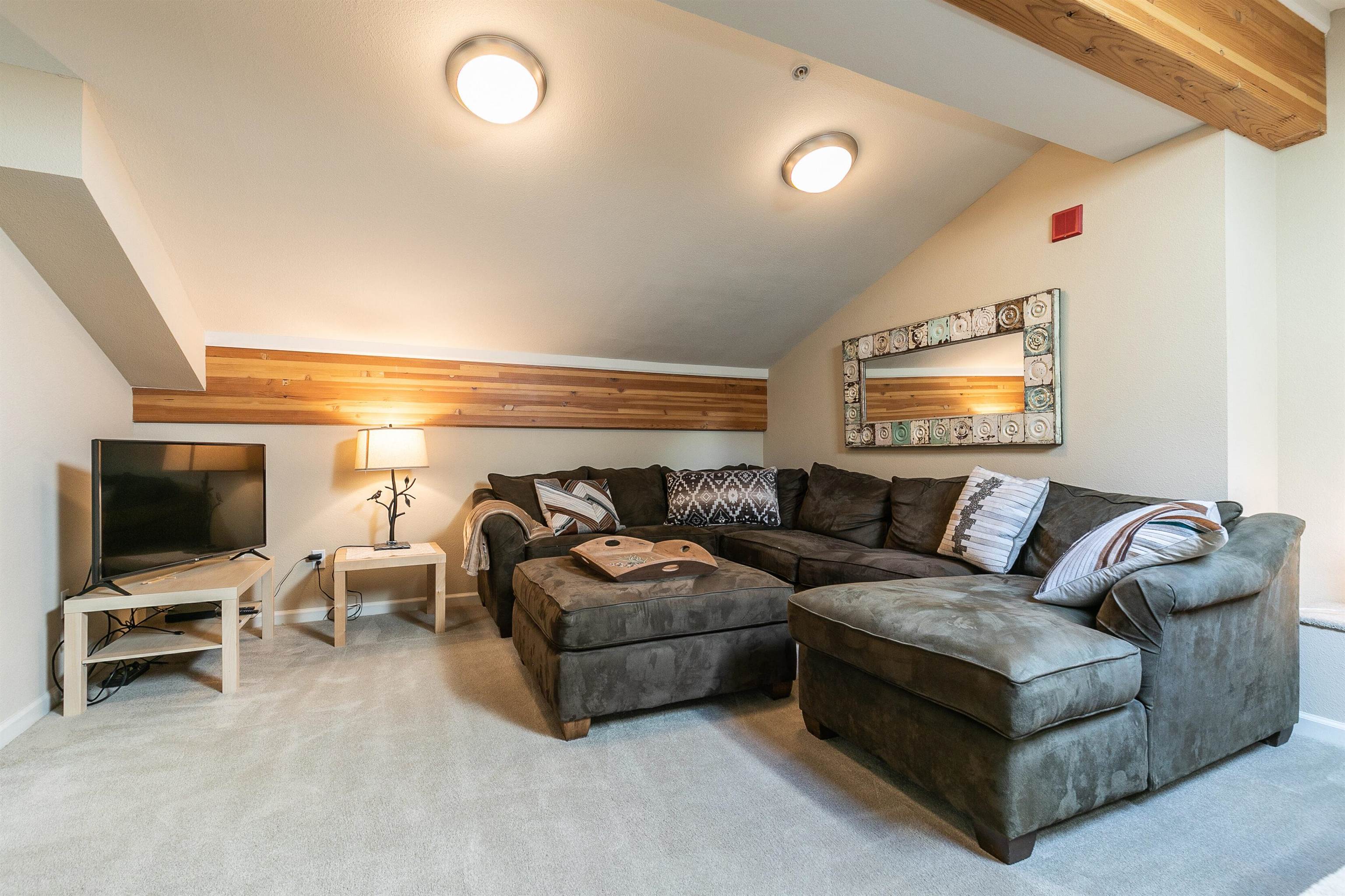 227 Olympic Vly Road, Unit 52 Olympic Valley, CA 96146 - Photo 9 of 21 a living room with furniture and a flat screen tv