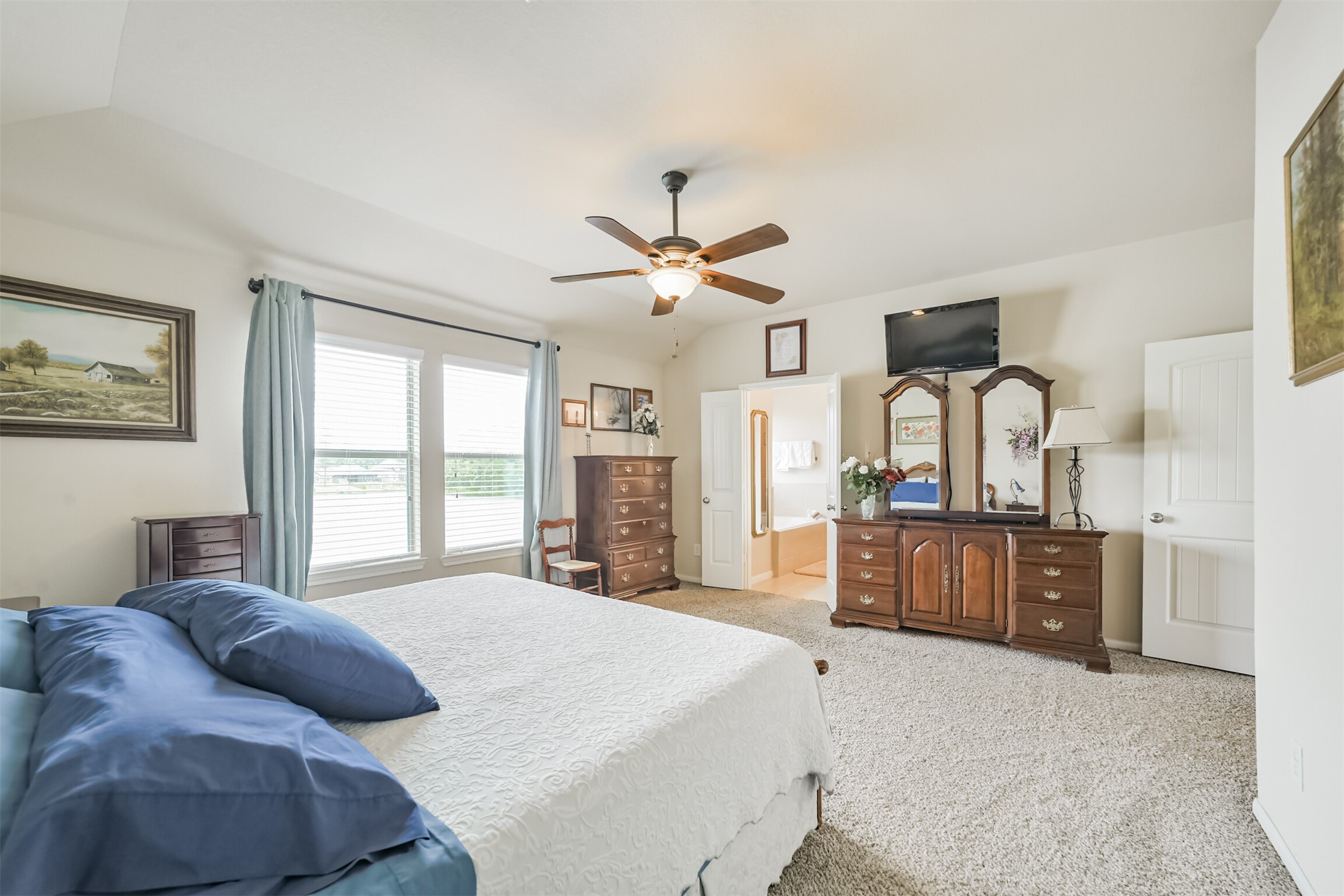12009 La Salle River Road Conroe, TX 77304 - Photo 26 of 50 a bedroom with a large bed and a large window