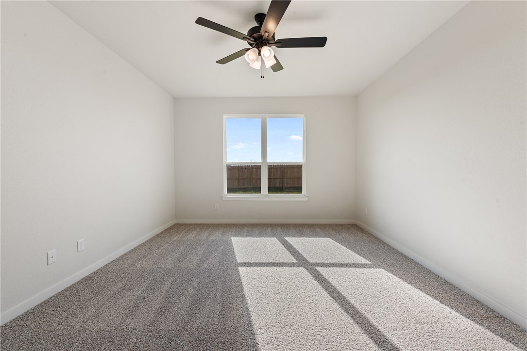 2415 Rooke Road Bryan, TX 77807 - Photo 26 of 36 an empty room with chandelier fan and windows