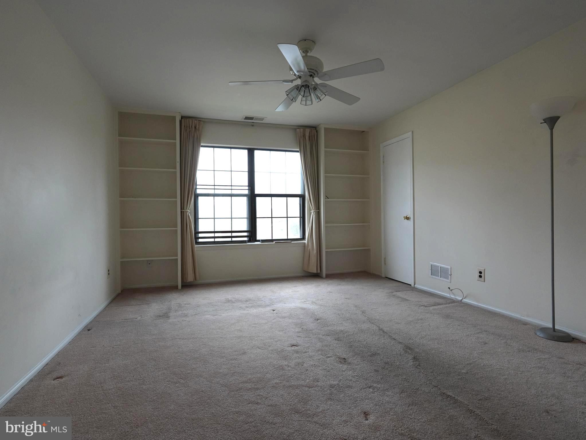 130 B Birchfield Court Mount Laurel, NJ 08054 - Photo 13 of 14 an empty room with windows and ceiling fan