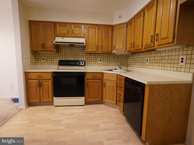 a kitchen with stainless steel appliances granite countertop a stove sink and cabinets