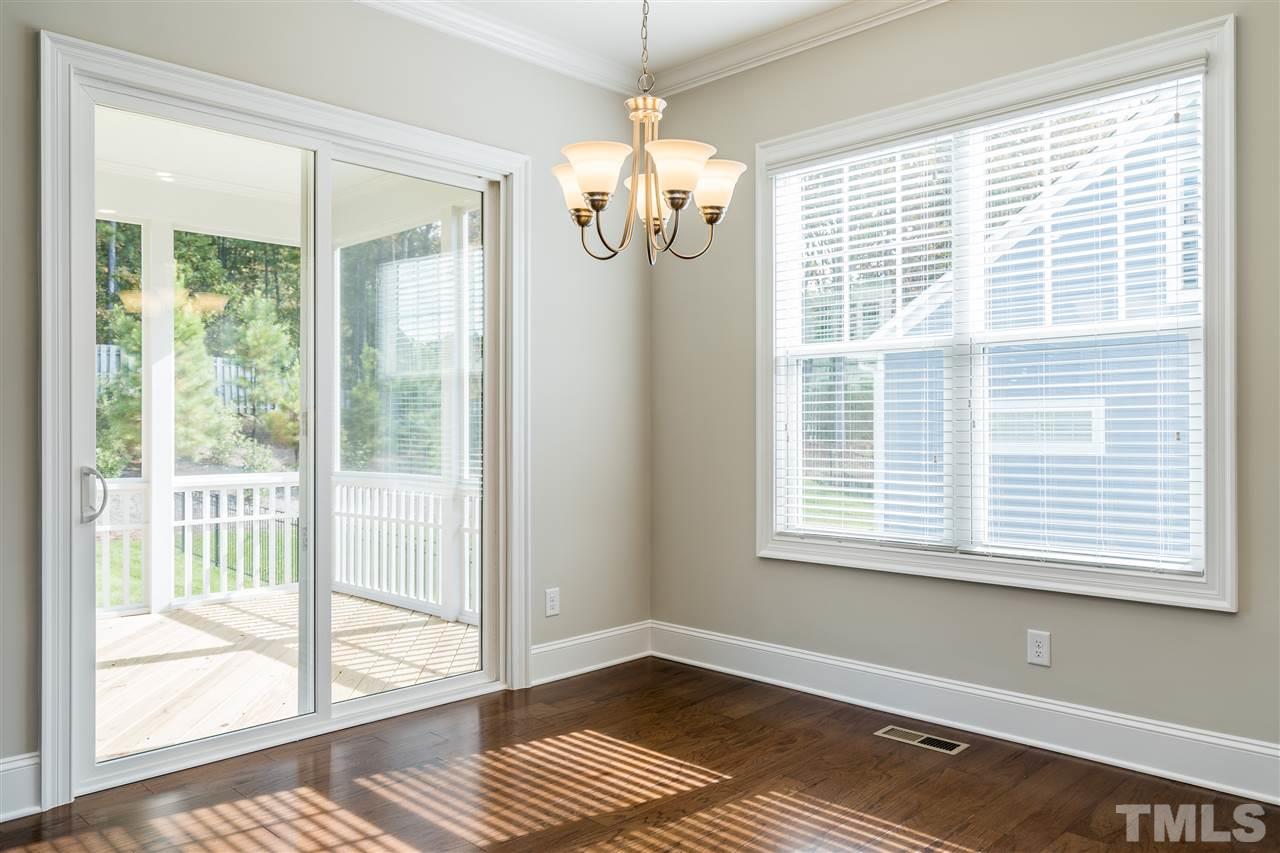 5928 Bellona Lane Raleigh, NC 27612 - Photo 11 of 25 a view of an empty room with wooden floor and a window