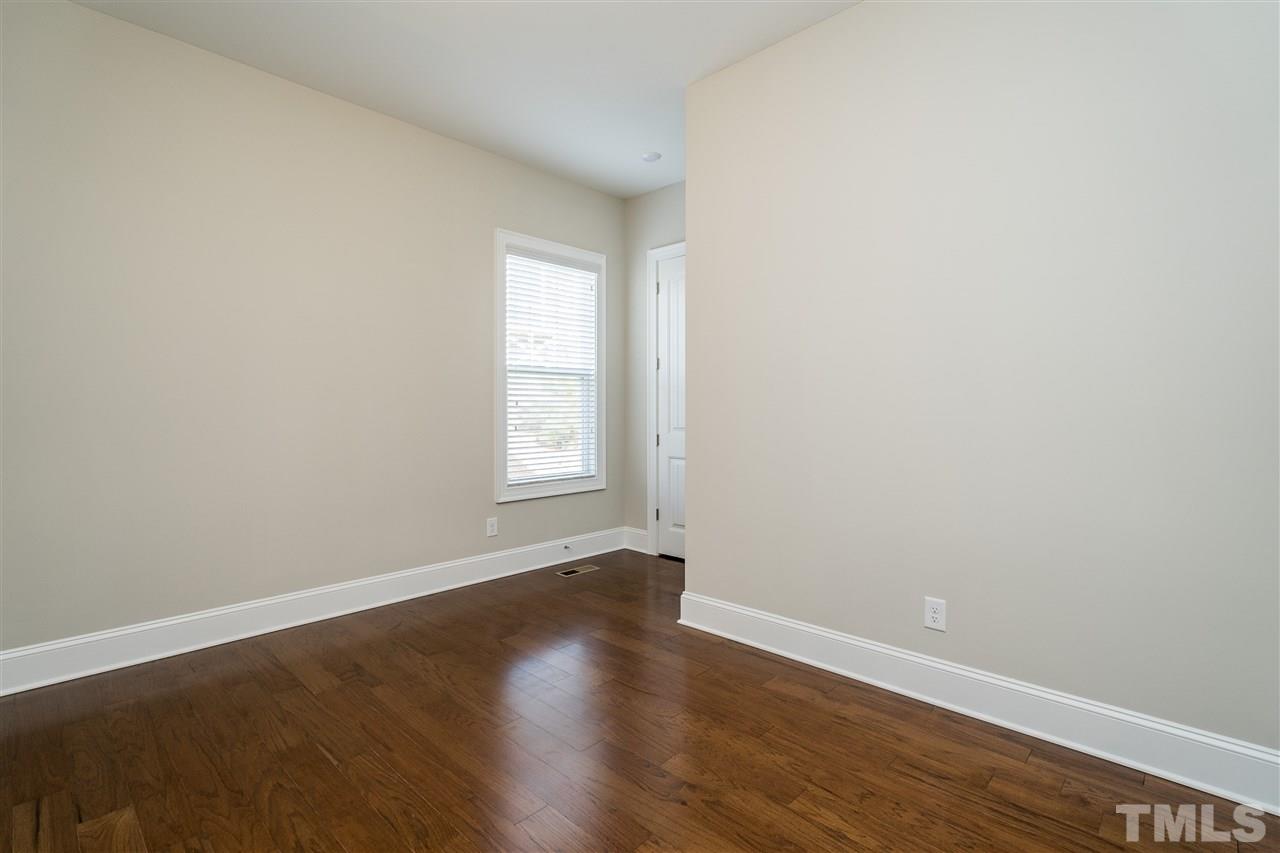 5928 Bellona Lane Raleigh, NC 27612 - Photo 14 of 25 an empty room with wooden floor and windows