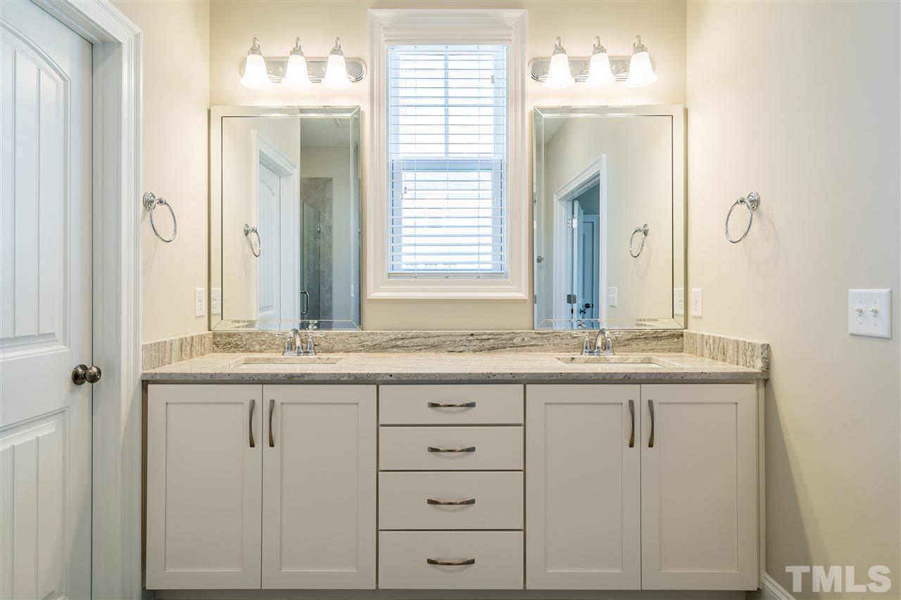 5928 Bellona Lane Raleigh, NC 27612 - Photo 18 of 25 a bathroom with a granite countertop sink and a mirror