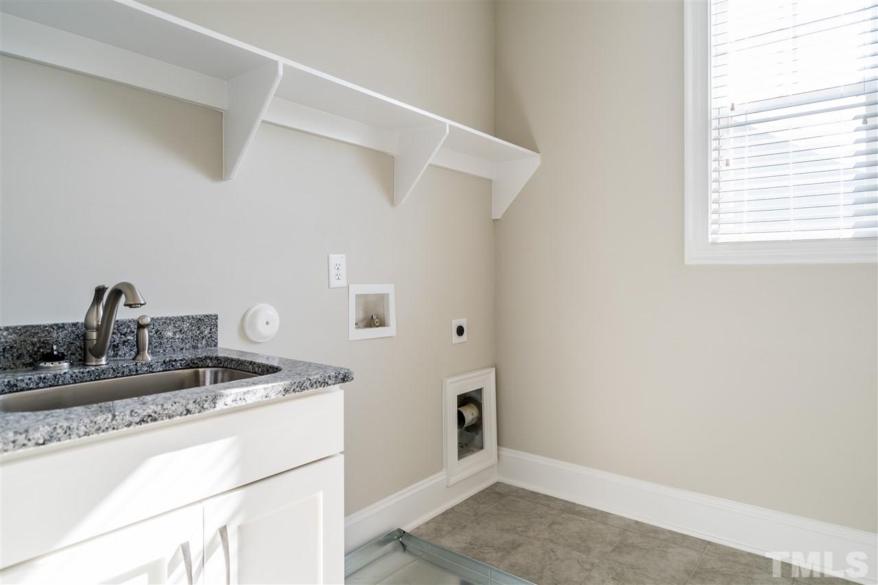 5928 Bellona Lane Raleigh, NC 27612 - Photo 24 of 25 a kitchen with a sink cabinets and appliances