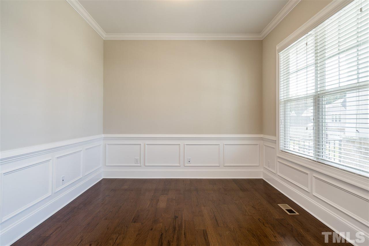 5928 Bellona Lane Raleigh, NC 27612 - Photo 6 of 25 a view of an empty room with wooden floor and a window