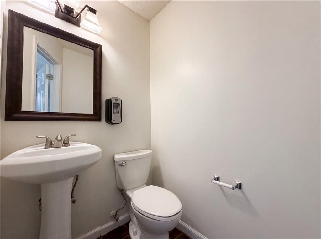 3753 Soapstone Road Decatur, GA 30034 - Photo 19 of 26 a bathroom with a toilet sink and mirror