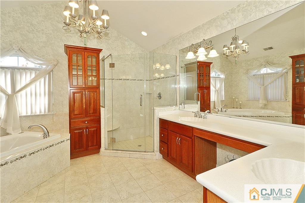 1 Conor Road Jackson, NJ 08527 - Photo 17 of 25 a spacious bathroom with a granite countertop sink a large mirror and a bathtub with shower
