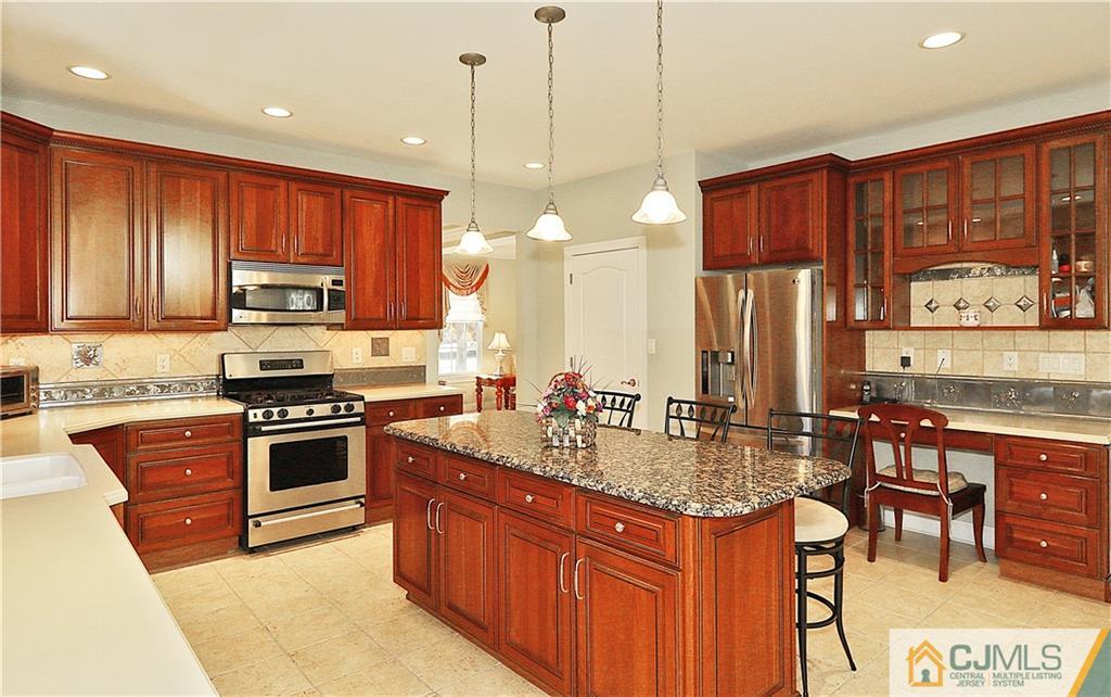 1 Conor Road Jackson, NJ 08527 - Photo 8 of 25 a kitchen with stainless steel appliances granite countertop a stove a sink and a refrigerator