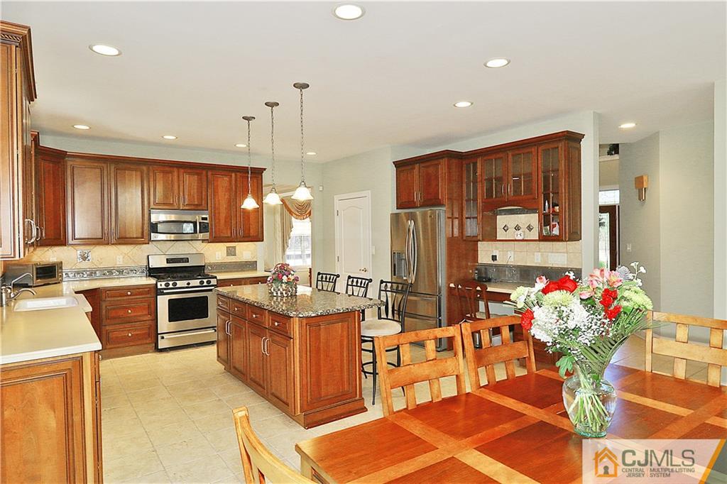 1 Conor Road Jackson, NJ 08527 - Photo 9 of 25 a kitchen with stainless steel appliances kitchen island granite countertop a stove refrigerator and cabinets