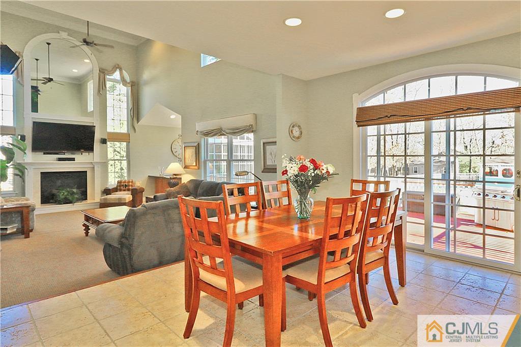 1 Conor Road Jackson, NJ 08527 - Photo 10 of 25 a dining room with furniture a flat screen tv and a chandelier