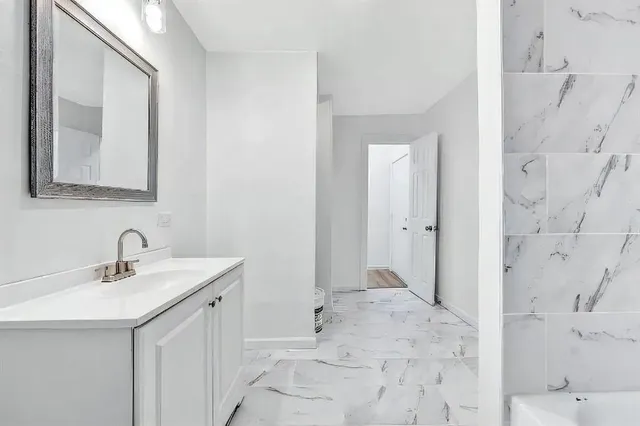 a bathroom with a sink and a mirror