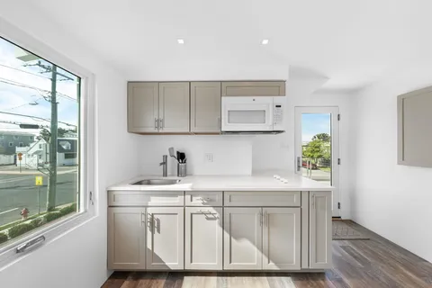 a view of balcony with wooden floor and outdoor seating