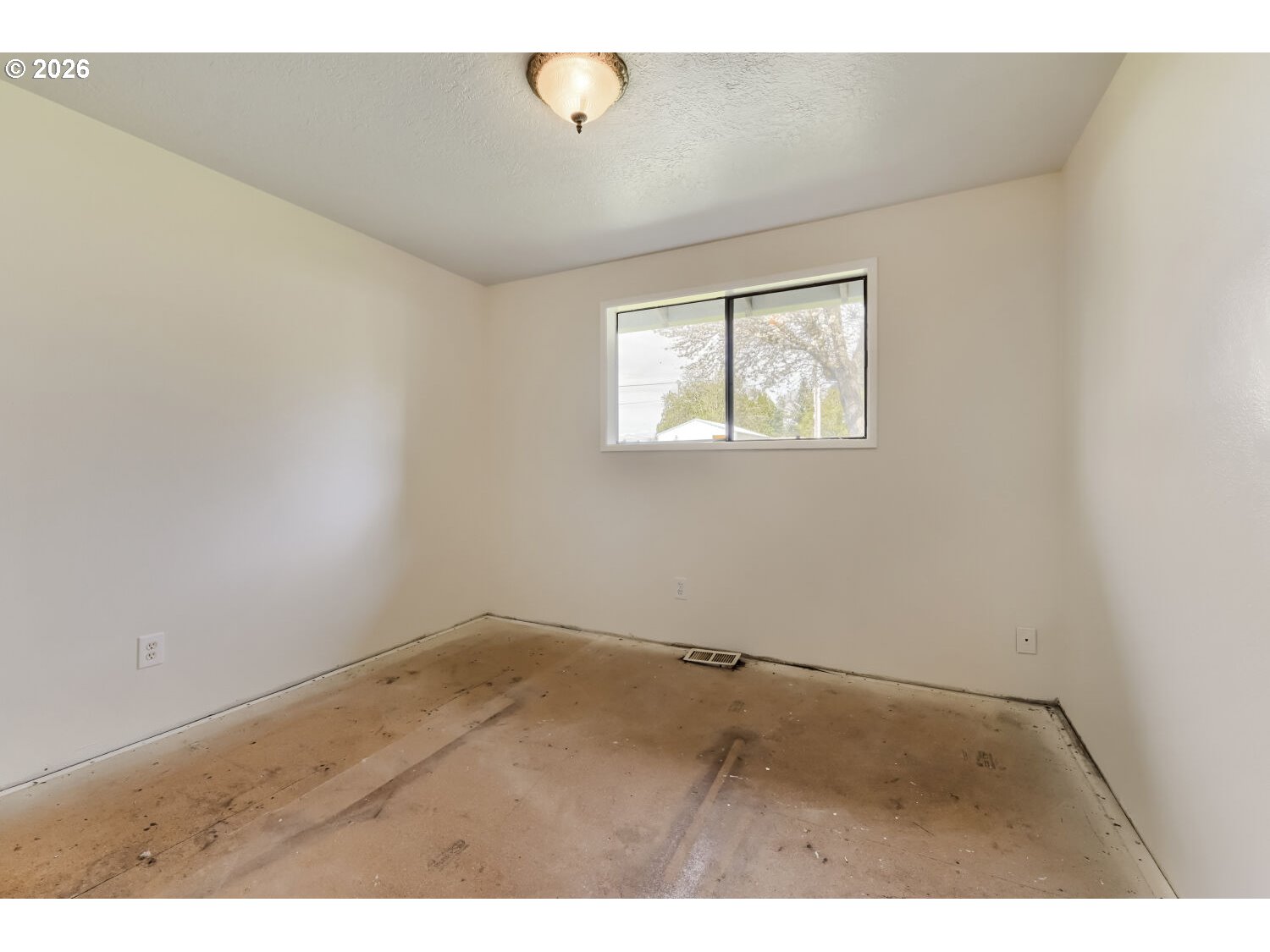 19710 Southwest Johnson Street Beaverton, OR 97003 - Photo 12 of 15 an empty room with wooden floor and windows