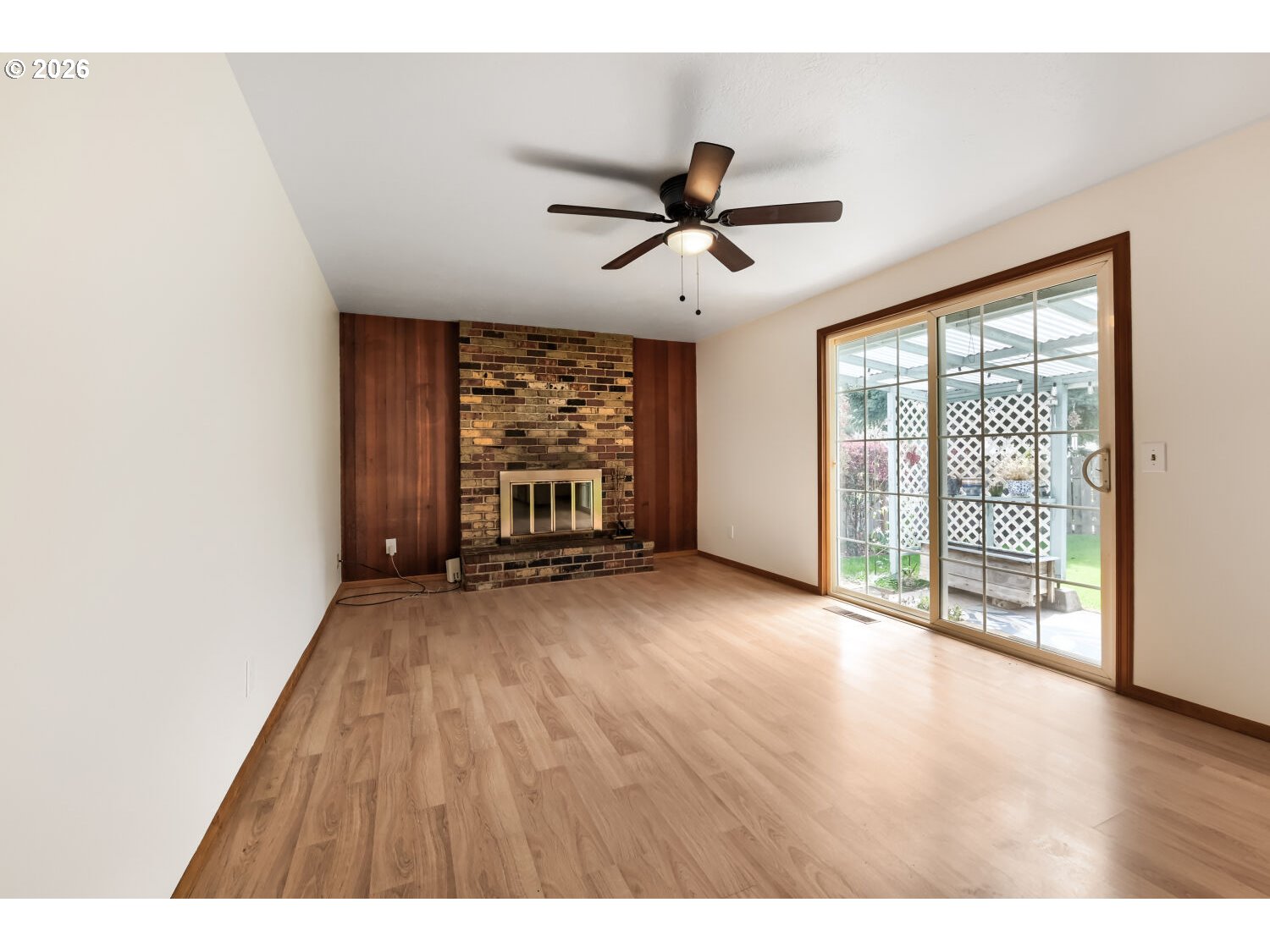 19710 Southwest Johnson Street Beaverton, OR 97003 - Photo 3 of 15 a view of empty room with wooden floor and fan