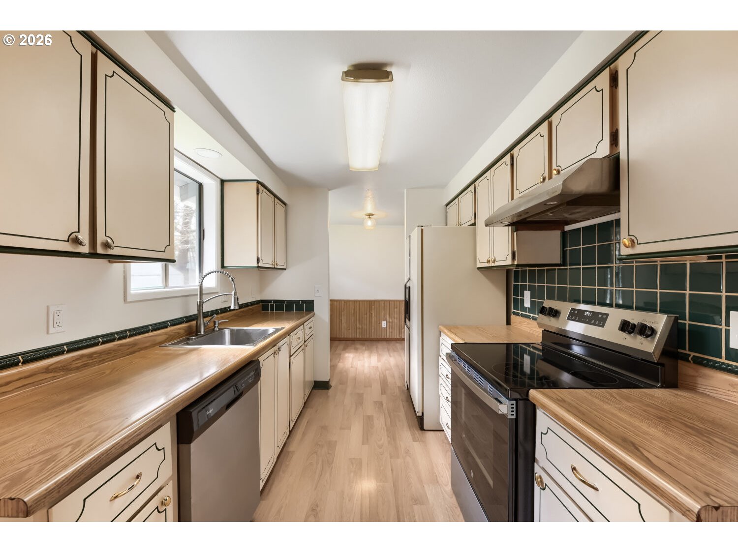 19710 Southwest Johnson Street Beaverton, OR 97003 - Photo 4 of 15 a kitchen with a sink stove top oven and cabinets