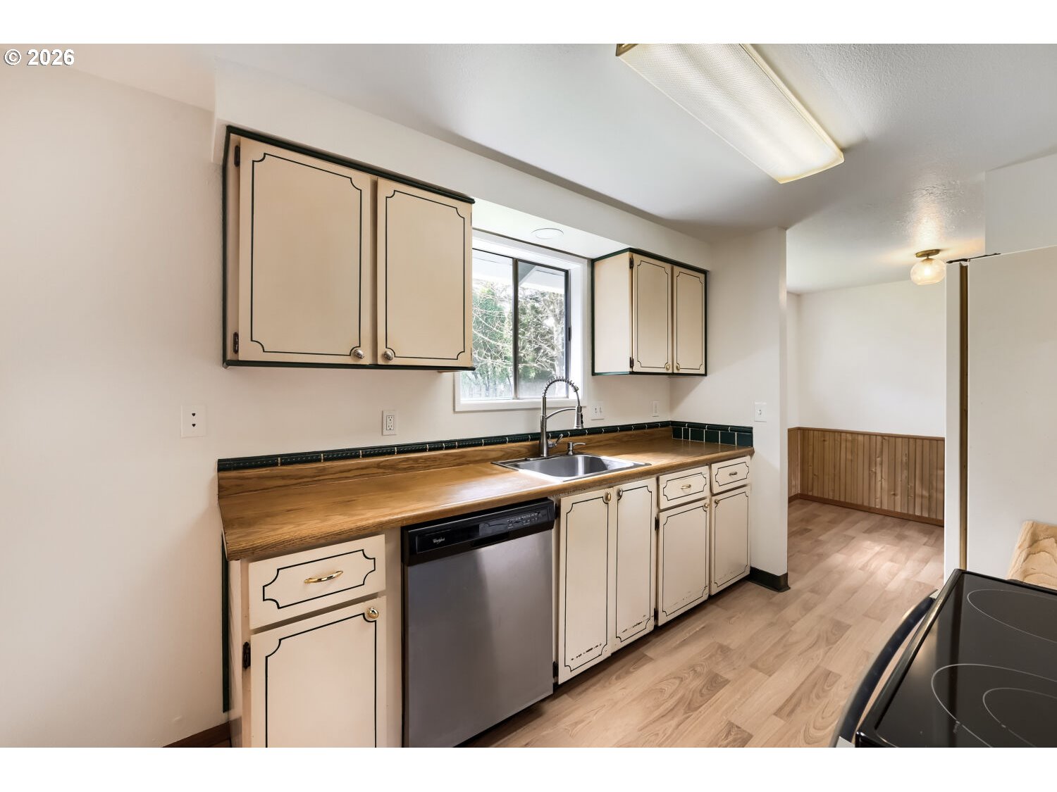 19710 Southwest Johnson Street Beaverton, OR 97003 - Photo 5 of 15 a kitchen with stainless steel appliances granite countertop a sink dishwasher a stove and a refrigerator with wooden floor
