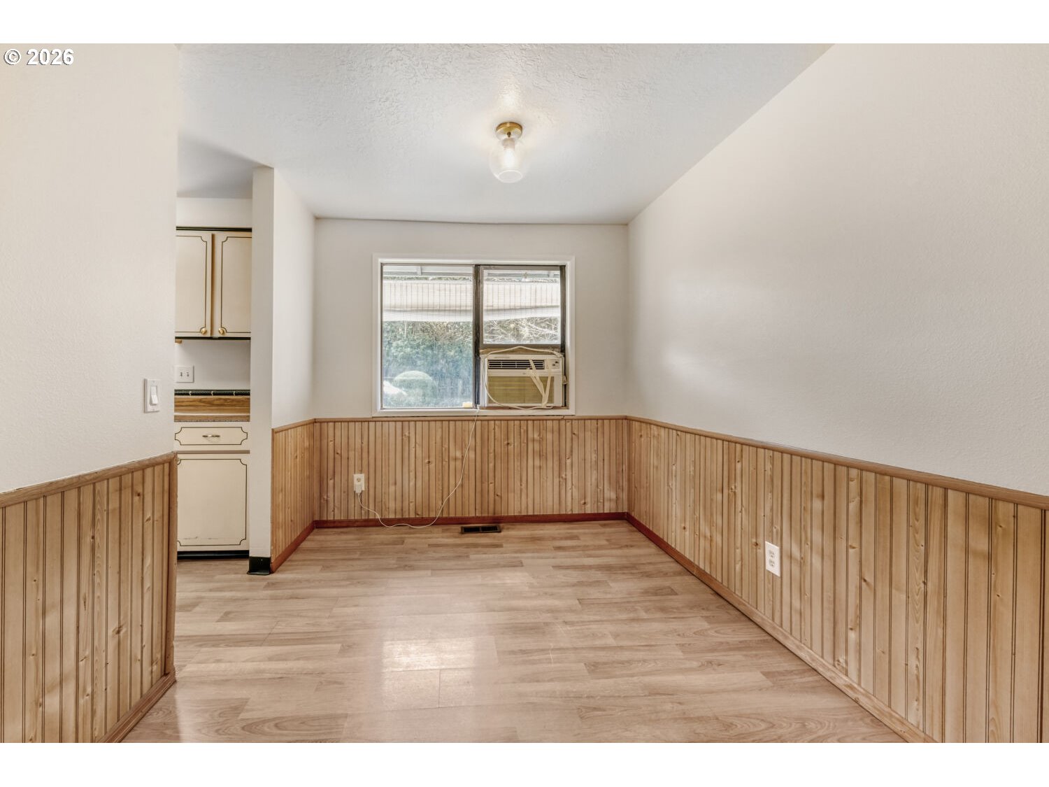 19710 Southwest Johnson Street Beaverton, OR 97003 - Photo 6 of 15 a view of an empty room with wooden floor and a window