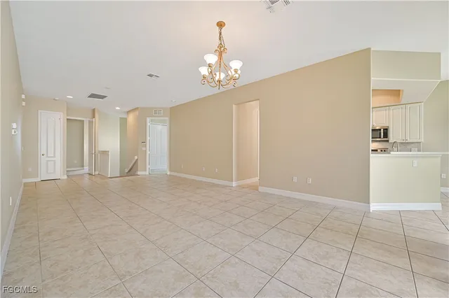 a view of an empty room with kitchen