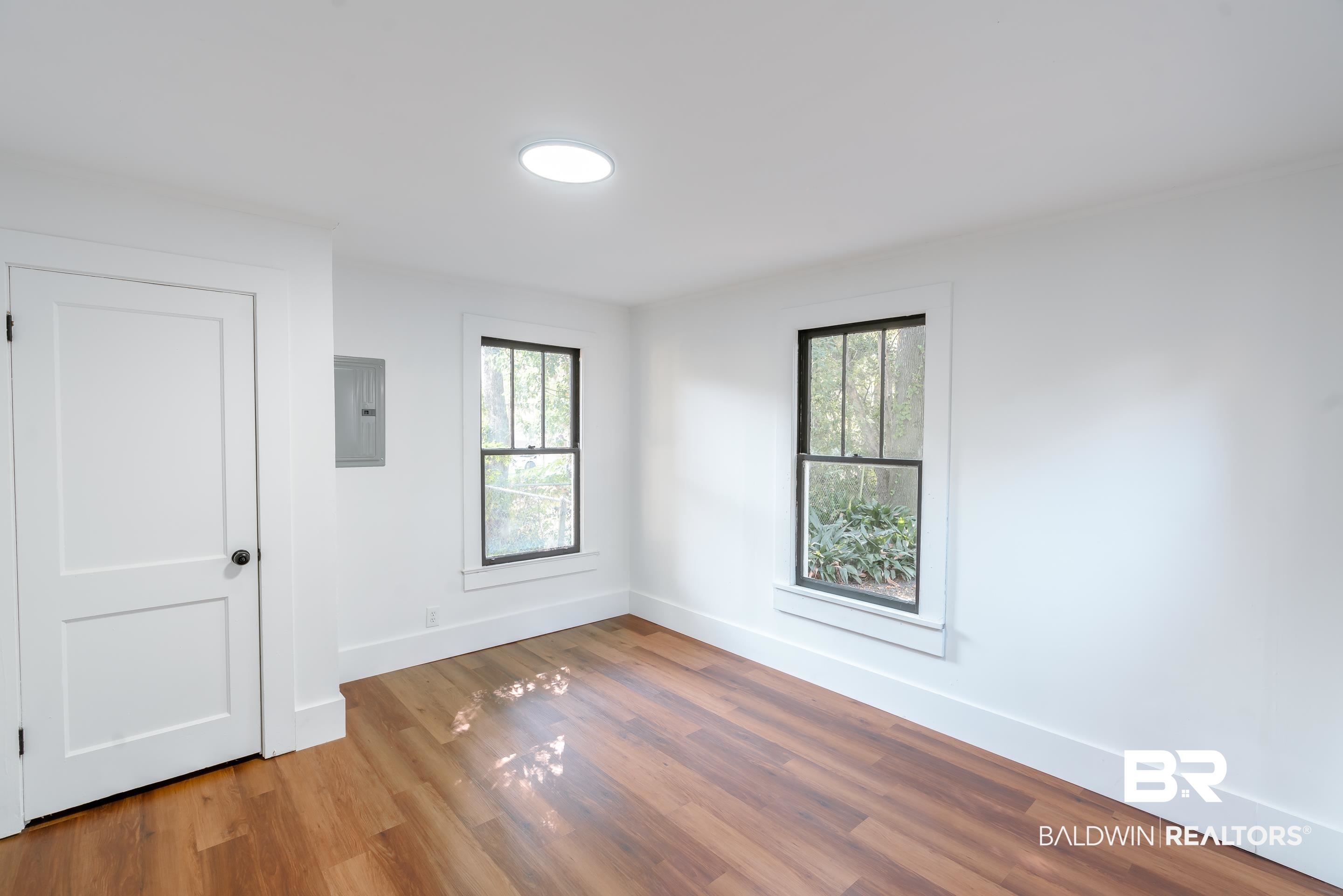 166 Crenshaw Street Mobile, AL 36606 - Photo 14 of 24 Spare room with hardwood / wood-style floors, a healthy amount of sunlight, and electric panel